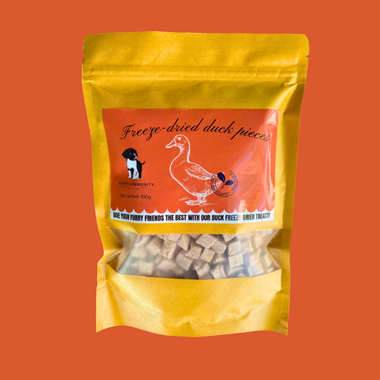 red background with kraft resealable bag. bag contains small squares of freeze dried duck.