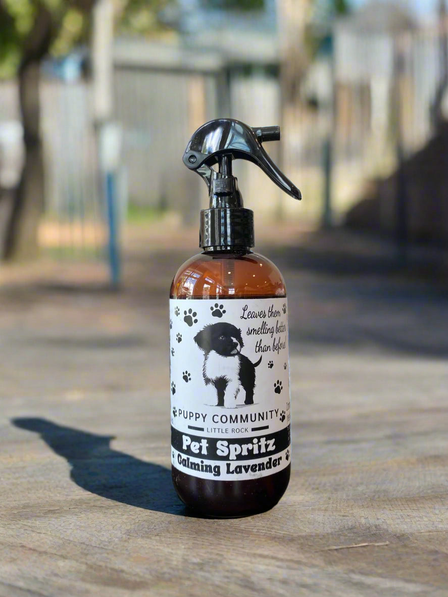 Bottle of 'Puppy Community' Pet Spritz on a table with a blurred background