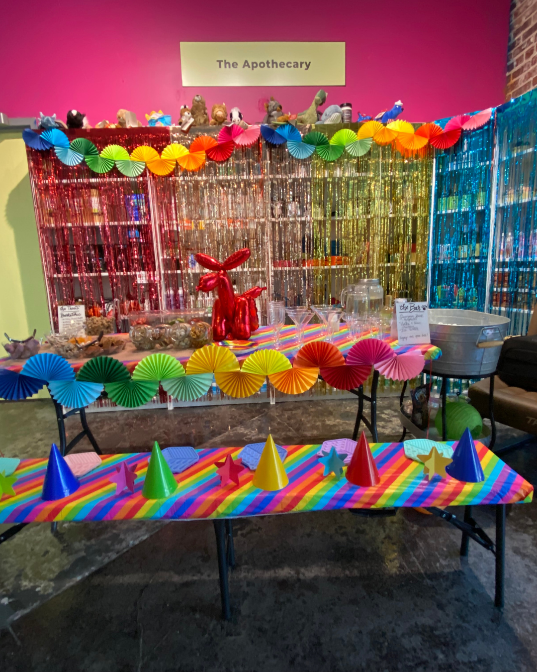 photo of the apothecary section of the store with party decorations and birthday streamers. the pup tasting bar is set up and ready to go.