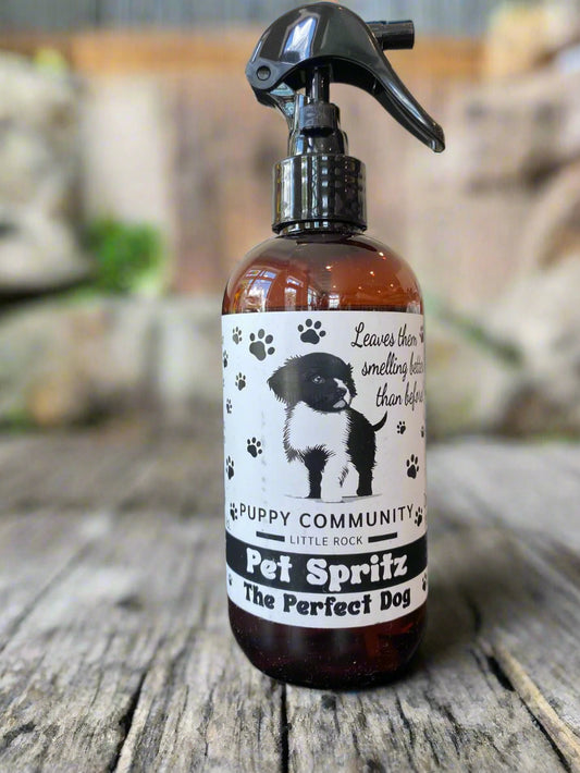 Pet Spritz bottle with a label featuring a dog on a black surface.