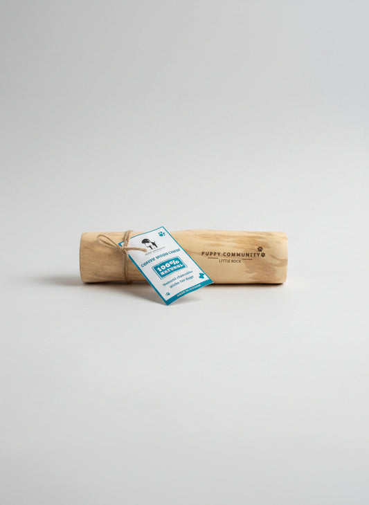 Wooden chew toy with a tag on a reflective surface