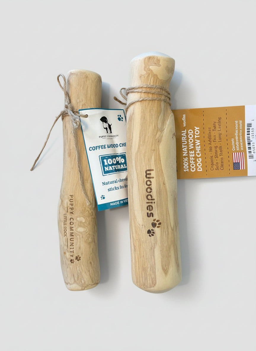 Two wooden dog chew toys with 'Woodies' branding on a dark surface.